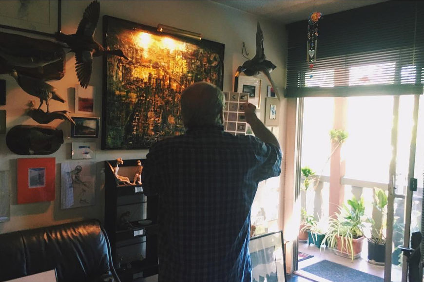 IMAGE: Photo - Sandy in his studio looking at slides